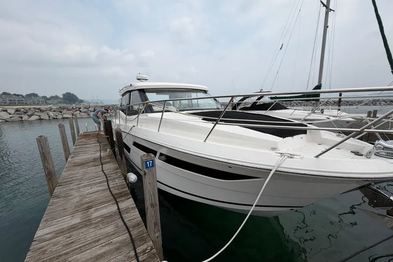 Slide: The Image of 2020 Regal 38 Grande Coupe docked at a marina, showcasing sleek design and modern features. - 2