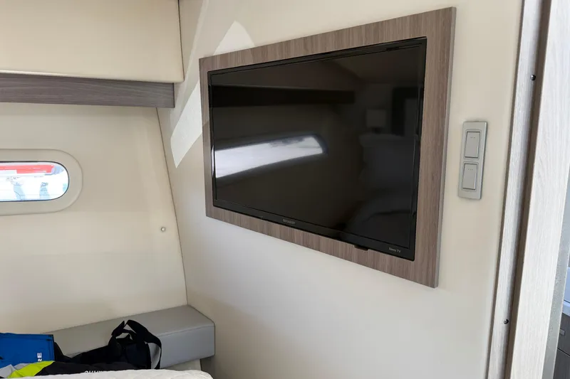Slide: The Image of Flat-screen TV in 2020 Regal 38 Grande Coupe interior cabin, near a small window. - 32