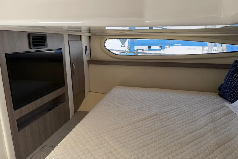 Slide: The Image of Interior of 2020 Regal 38 Grande Coupe with bed, TV, and window view. - 39