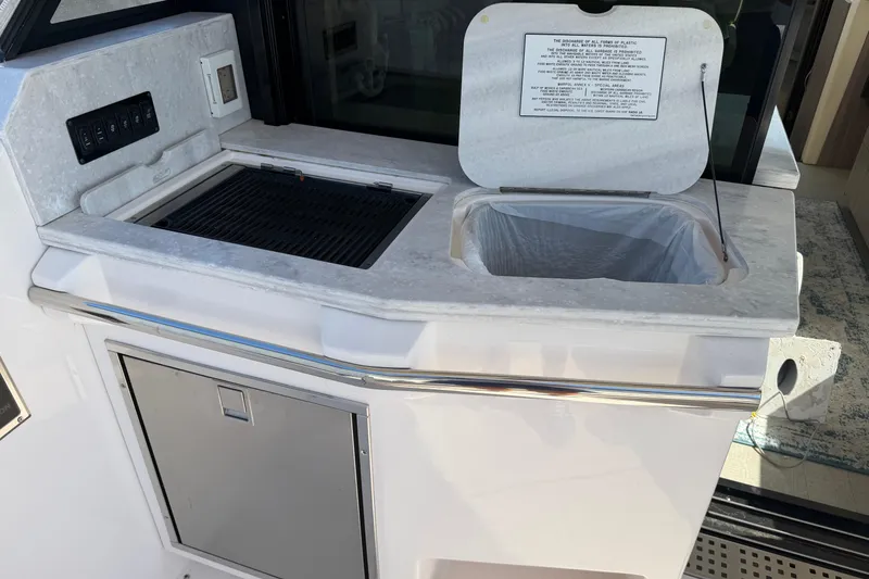 Slide: The Image of Outdoor kitchen area on a 2020 Regal 38 Grande Coupe yacht. - 14