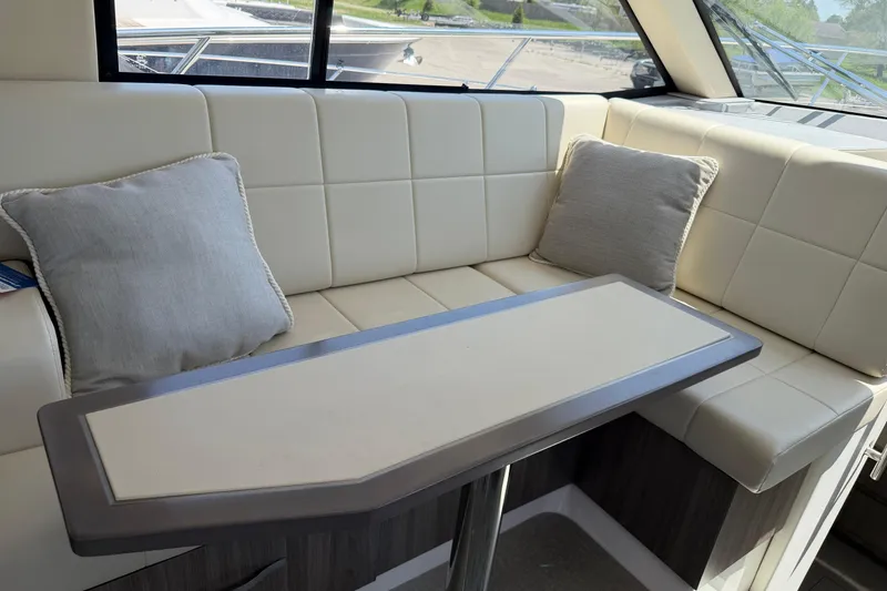 Slide: The Image of Interior of 2020 Regal 38 Grande Coupe with plush seating and modern table design. - 20