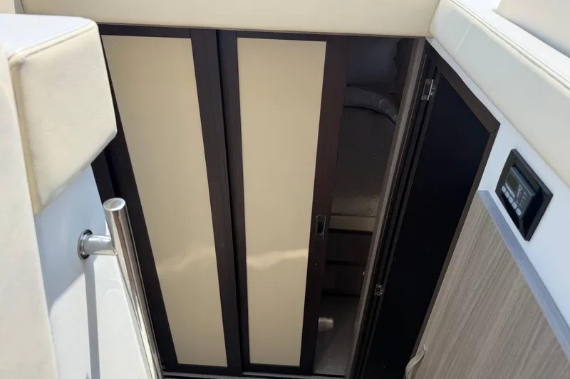 Slide: The Image of Interior cabin view of a 2020 Regal 38 Grande Coupe yacht, featuring sliding doors. - 33