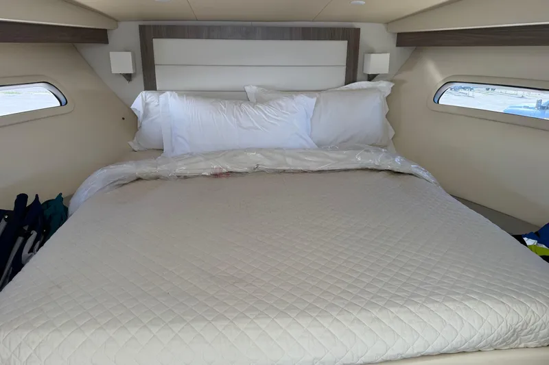 Slide: The Image of Luxurious bedroom interior of 2020 Regal 38 Grande Coupe yacht with plush bedding. - 29
