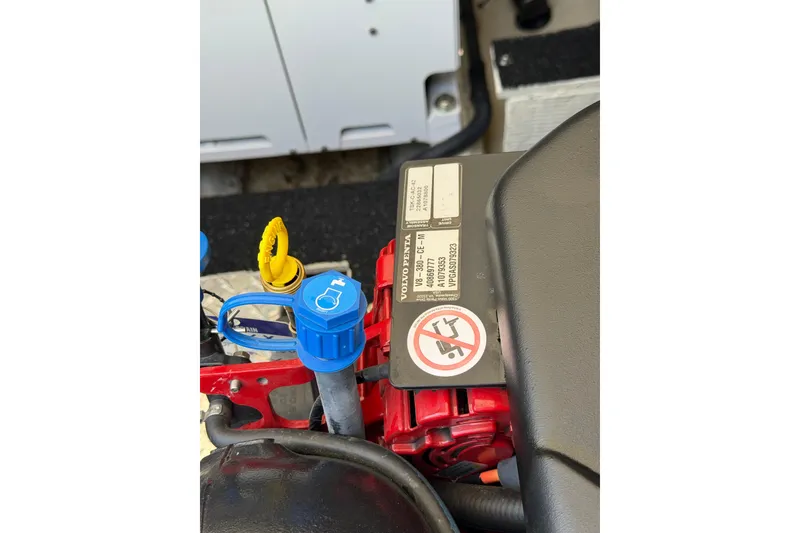 Slide: The Image of Engine compartment of a 2020 Regal 38 Grande Coupe with visible labels and components. - 43