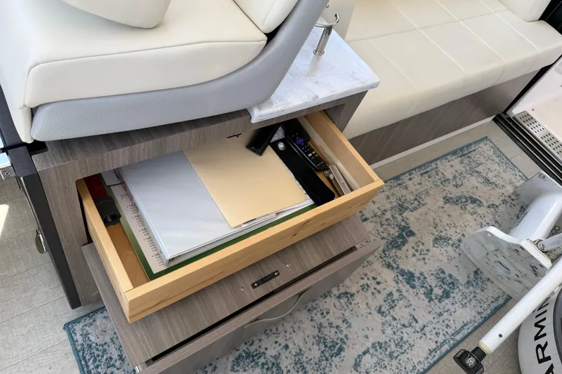 Slide: The Image of Open drawer with documents inside a 2020 Regal 38 Grande Coupe boat interior. - 25
