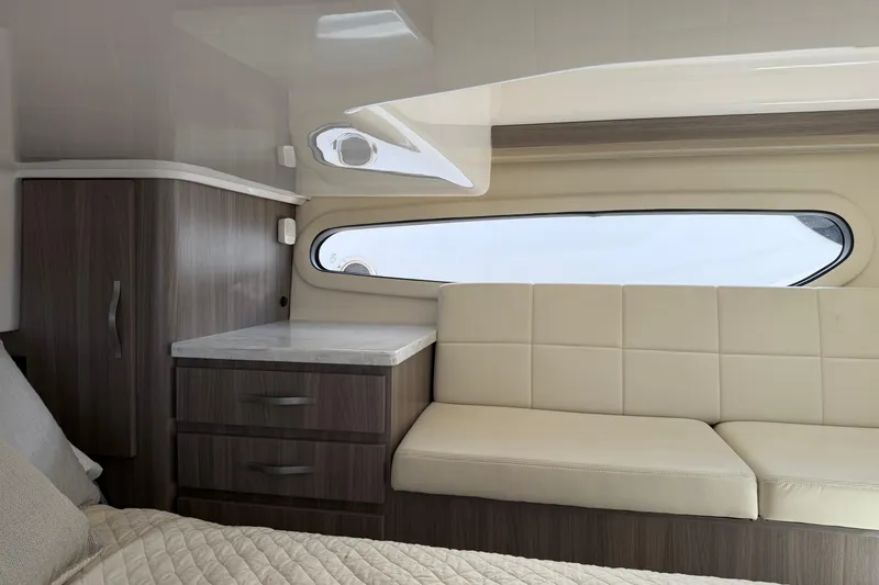 Slide: The Image of Interior of 2020 Regal 38 Grande Coupe with modern cabinetry and beige seating. - 40