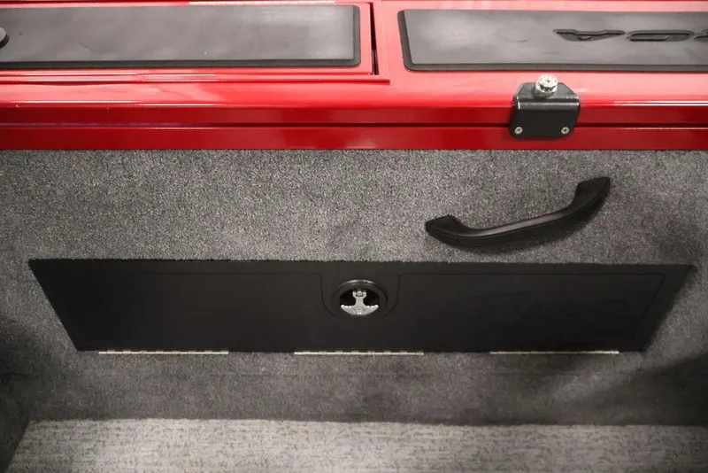 Slide: The Image of 2024 Tracker Targa V-18 Combo interior storage compartment with red and gray accents. - 34