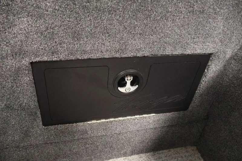 Slide: The Image of 2024 Tracker Targa V-18 Combo storage compartment with secure latch. - 61