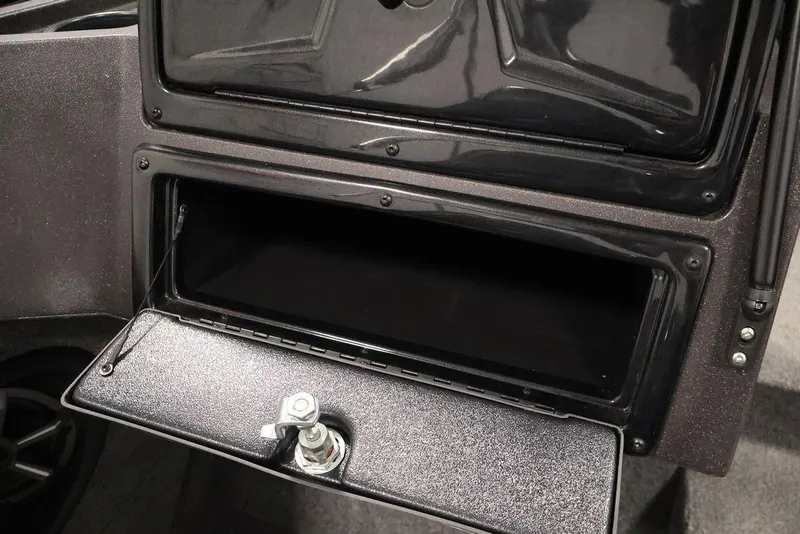 Slide: The Image of 2024 Tracker Targa V-18 Combo storage compartment with open hatch and secure latch. - 62