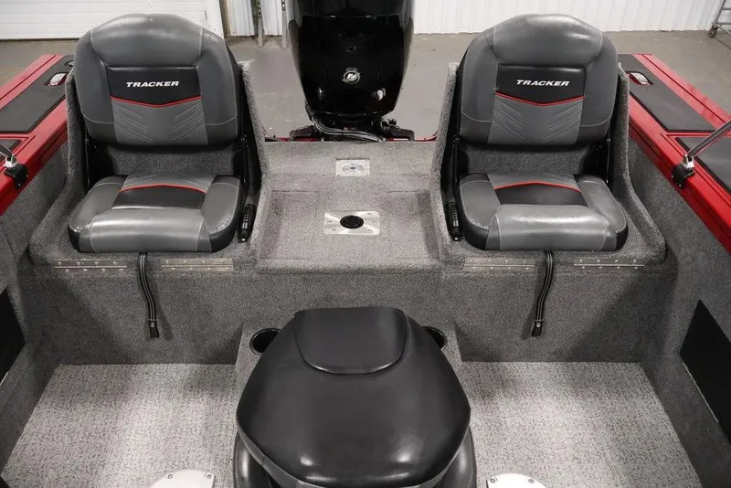 Slide: The Image of 2024 Tracker Targa V-18 Combo boat interior with two gray seats and red accents. - 27
