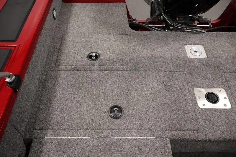 Slide: The Image of 2024 Tracker Targa V-18 Combo boat interior with gray carpet and red accents. - 38