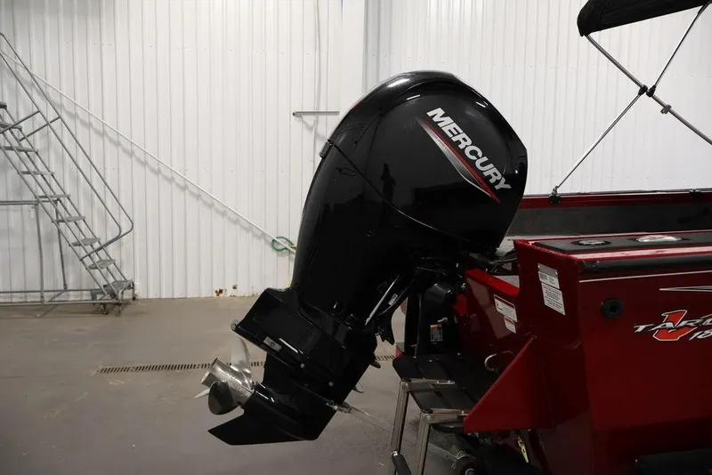 Slide: The Image of 2024 Tracker Targa V-18 Combo with Mercury outboard motor in a garage setting. - 43