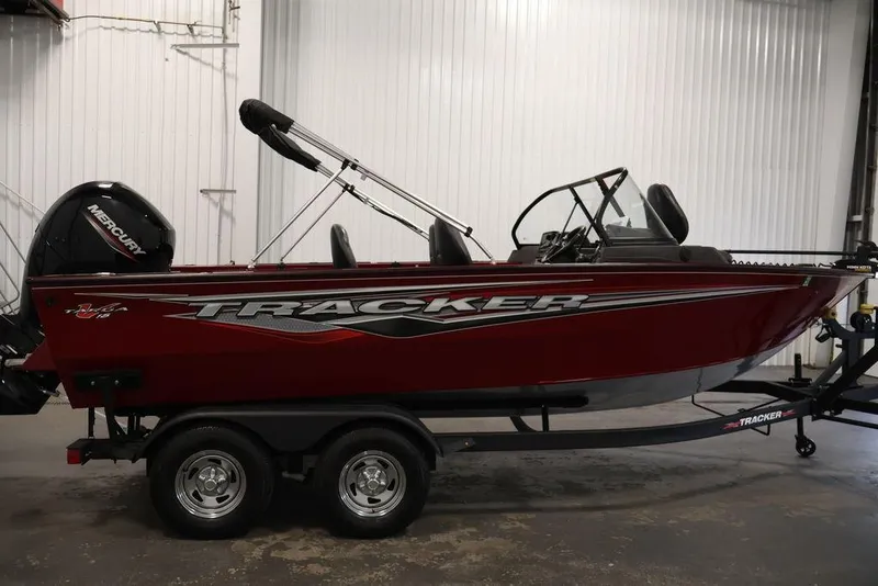 Slide: The Image of 2024 Tracker Targa V-18 Combo boat in a showroom, featuring a sleek red design. - 24
