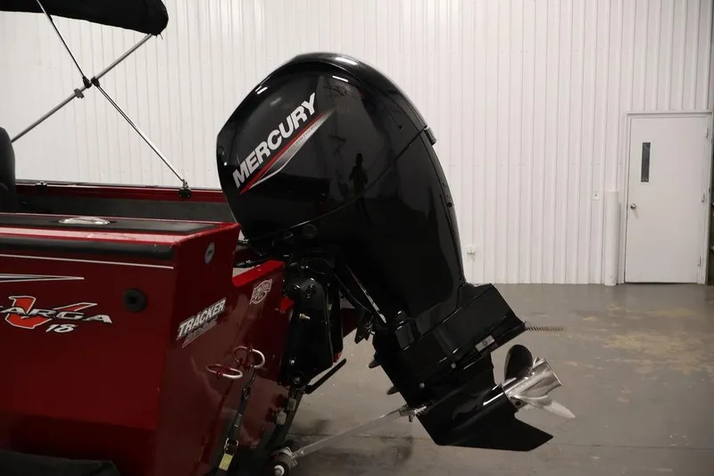 Slide: The Image of 2024 Tracker Targa V-18 Combo boat with Mercury outboard motor in a garage setting. - 46