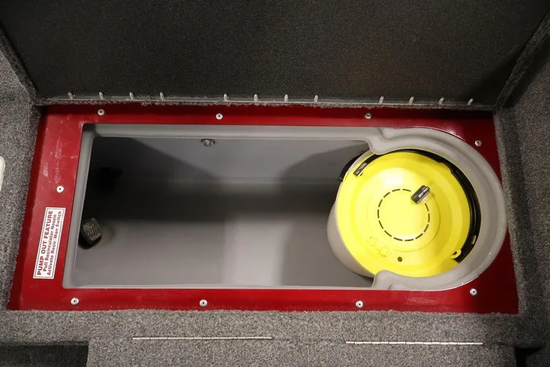 Slide: The Image of 2024 Tracker Targa V-18 Combo storage compartment with yellow lid and pump-out feature. - 47