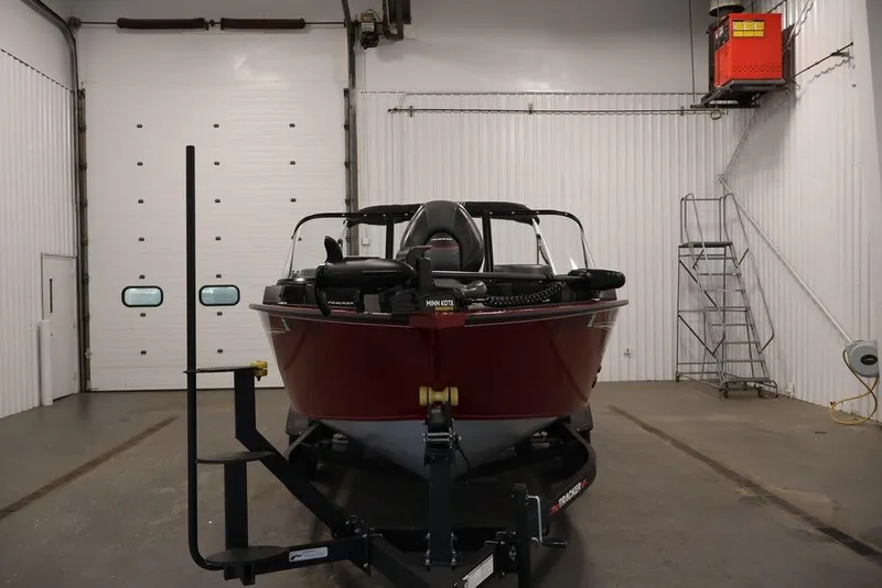 Slide: The Image of 2024 Tracker Targa V-18 Combo boat in a garage, front view. - 28