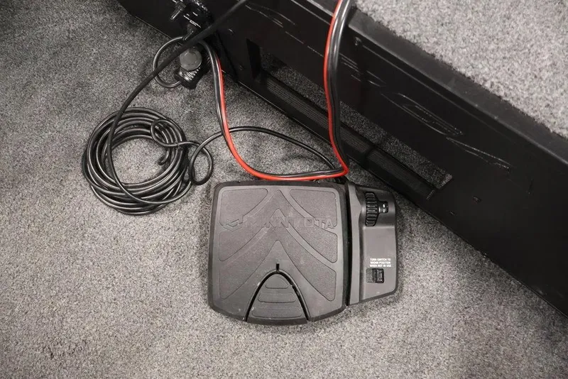 Slide: The Image of Foot pedal control in 2024 Tracker Targa V-18 Combo boat, with coiled cables. - 39