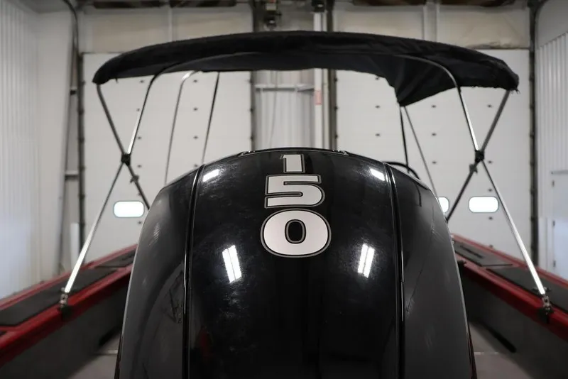 Slide: The Image of 2024 Tracker Targa V-18 Combo boat with 150 horsepower engine in a garage. - 55