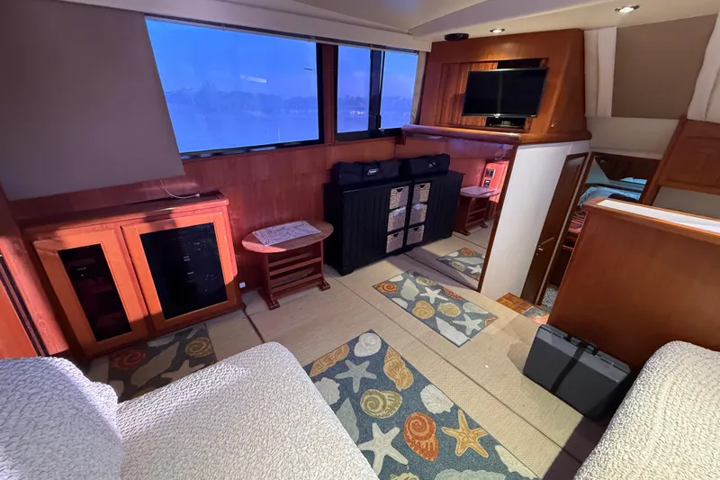 Slide: The Image of Interior of a 1989 Viking 35 Convertible yacht with cozy seating and nautical decor. - 22