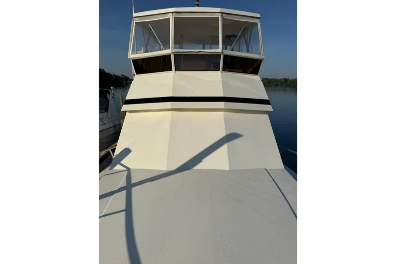 Slide: The Image of 1989 Viking 35 Convertible yacht with enclosed flybridge on calm water. - 11