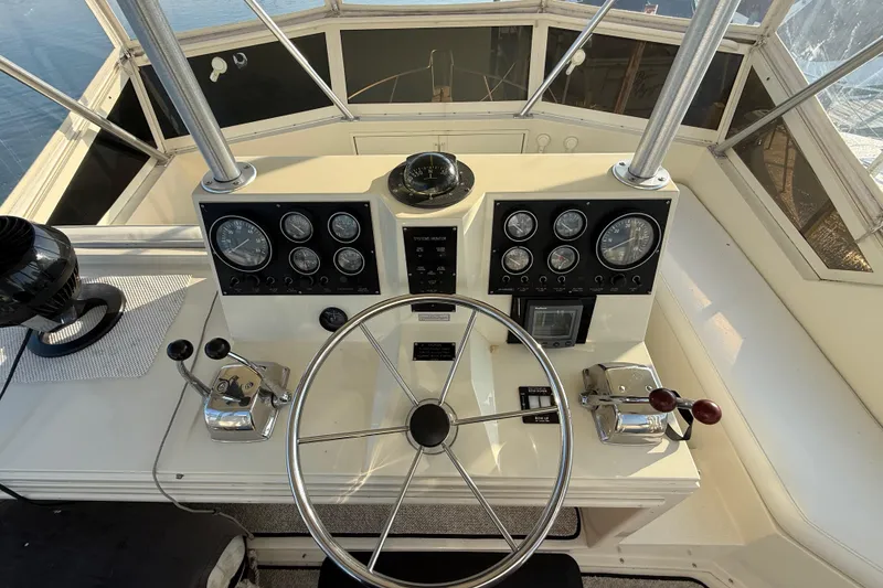 Slide: The Image of 1989 Viking 35 Convertible boat helm with steering wheel and control panels. - 18