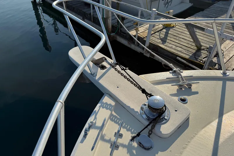 Slide: The Image of Bow of 1989 Viking 35 Convertible yacht with anchor chain and dock view. - 8