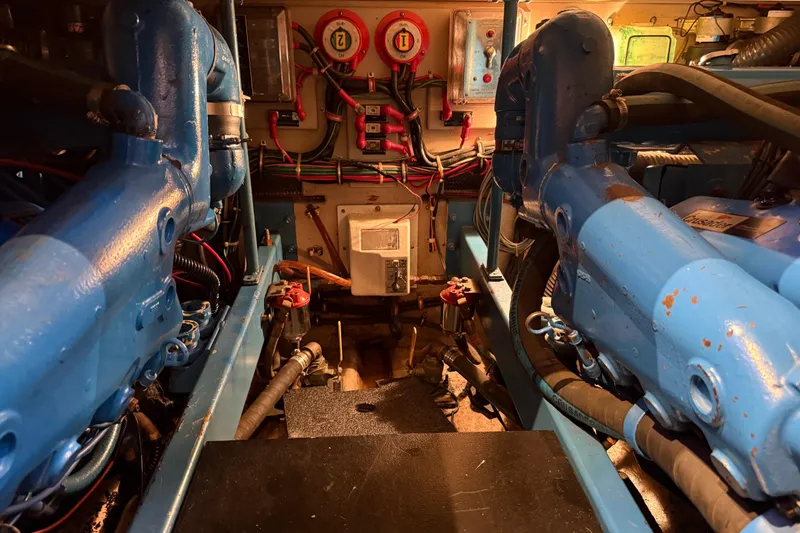 Slide: The Image of Engine room of a 1989 Viking 35 Convertible boat, featuring blue machinery and wiring. - 35