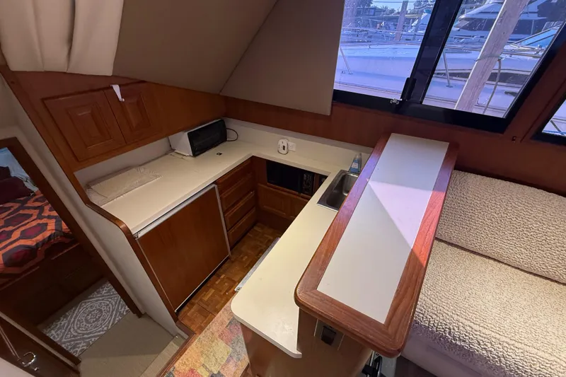 Slide: The Image of Interior of 1989 Viking 35 Convertible yacht with kitchenette and seating area. - 26
