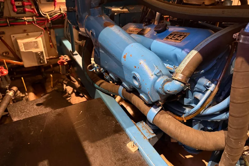 Slide: The Image of Engine compartment of a 1989 Viking 35 Convertible boat, featuring a blue Crusader 454 engine. - 36