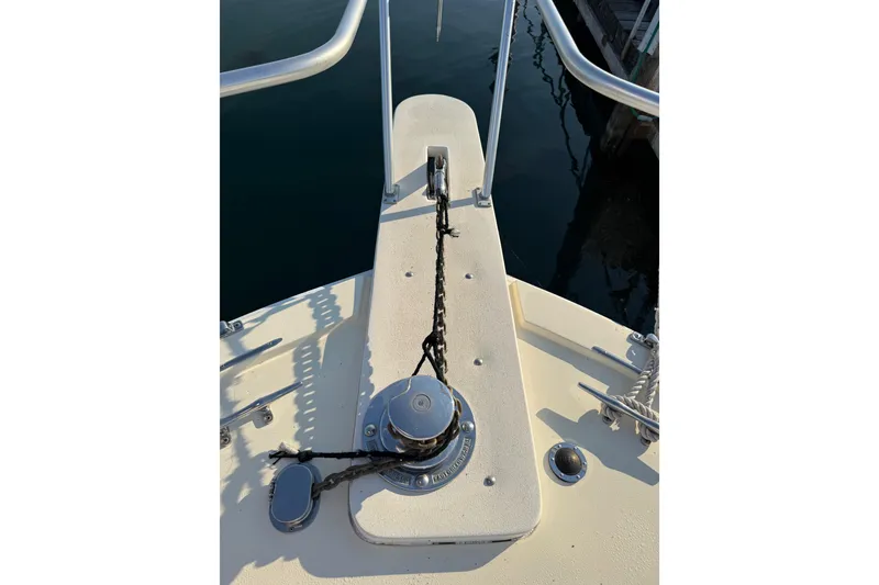 Slide: The Image of Bow of 1989 Viking 35 Convertible boat with anchor chain and winch. - 9