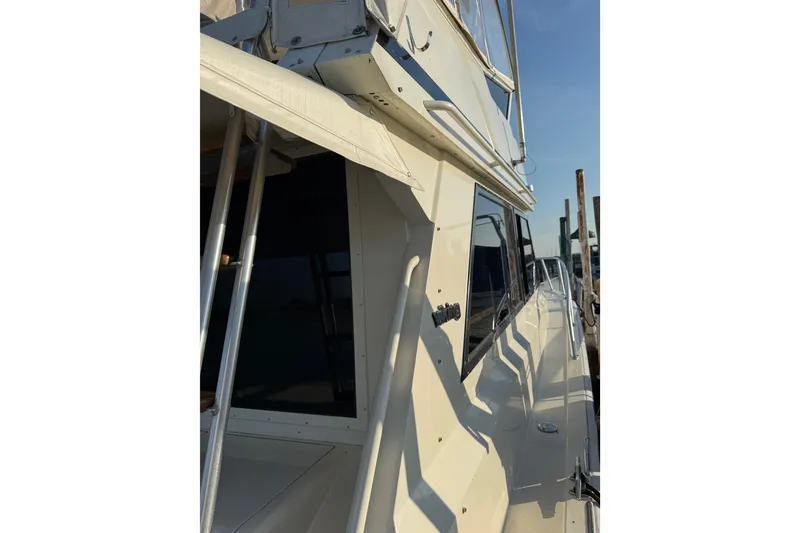 Slide: The Image of 1989 Viking 35 Convertible yacht side view with windows and railing. - 5