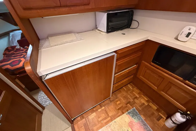 Slide: The Image of 1989 Viking 35 Convertible yacht kitchen with wooden cabinetry and appliances. - 27