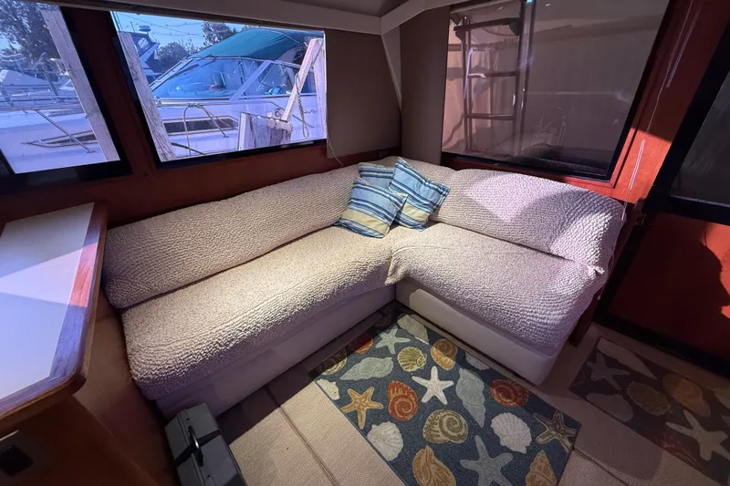 Slide: The Image of Cozy interior of 1989 Viking 35 Convertible yacht with plush seating and nautical decor. - 23