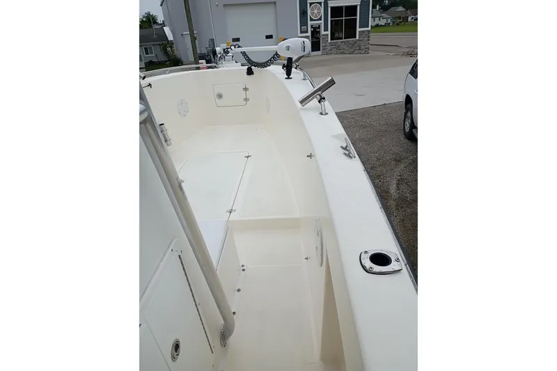 Slide: The Image of 2002 Paramount Supper Fish boat interior with clean white deck and fishing rod holders. - 6
