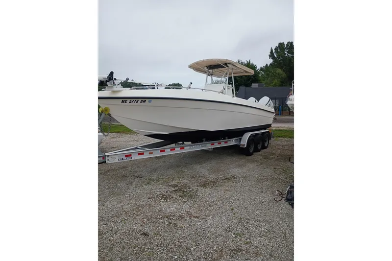 The Image of 2002 Paramount Supper Fish boat on a trailer, parked on gravel. - 0