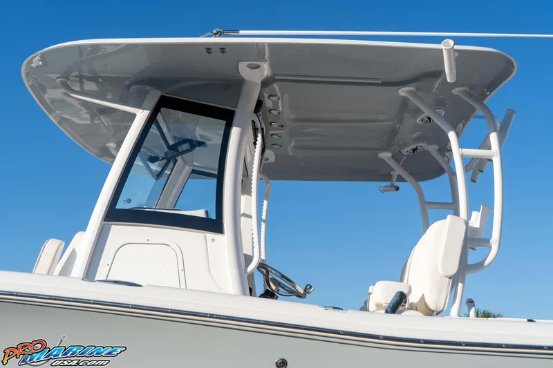 Slide: The Image of 2026 Sea Hunt Ultra 285 SE boat with T-top against clear blue sky. - 22