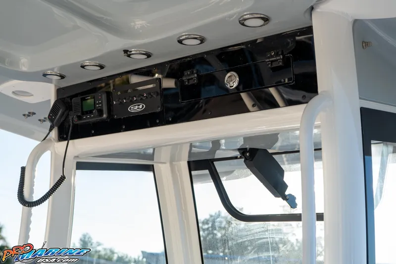 Slide: The Image of 2026 Sea Hunt Ultra 285 SE boat console with electronic controls and radio system. - 25