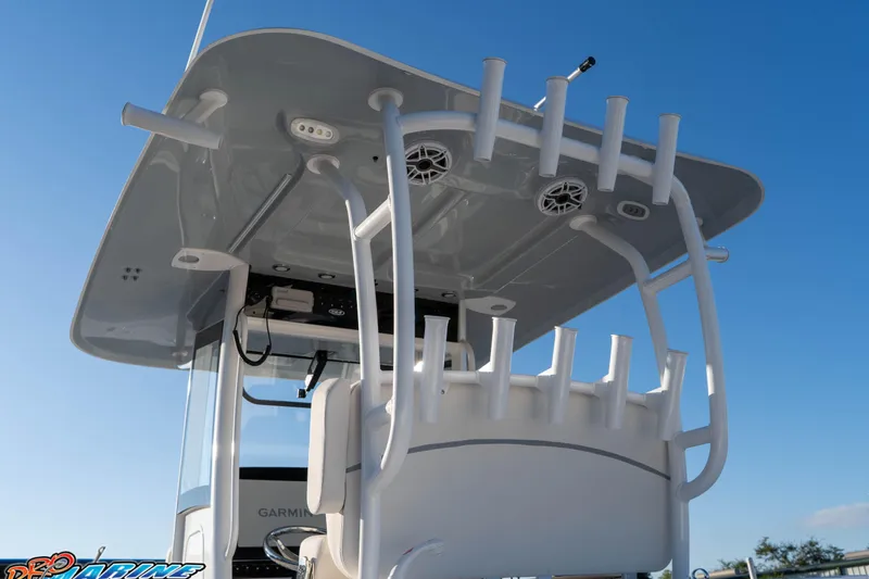 Slide: The Image of 2026 Sea Hunt Ultra 285 SE boat with rod holders and electronics under a clear blue sky. - 21