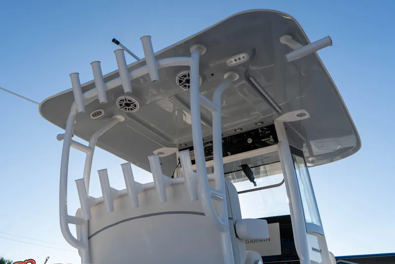 Slide: The Image of 2026 Sea Hunt Ultra 285 SE boat with rod holders and speakers under a clear blue sky. - 20