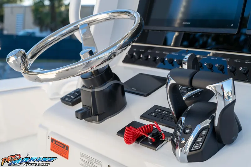 Slide: The Image of Steering console of 2026 Sea Hunt Ultra 285 SE boat with modern controls. - 24