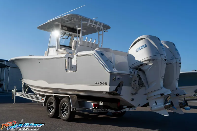 Slide: The Image of 2026 Sea Hunt Ultra 285 SE boat with dual Yamaha engines on a trailer. - 16