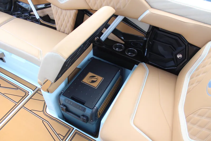 Slide: The Image of 2026 Tigé 24RZX boat interior with tan seating and integrated storage. - 13