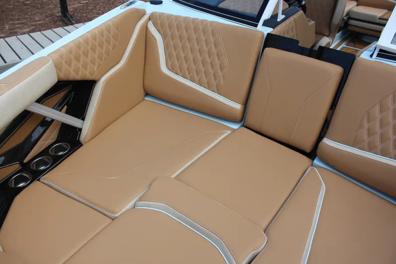 Slide: The Image of 2026 Tigé 24RZX boat interior with tan leather seating and cup holders. - 9