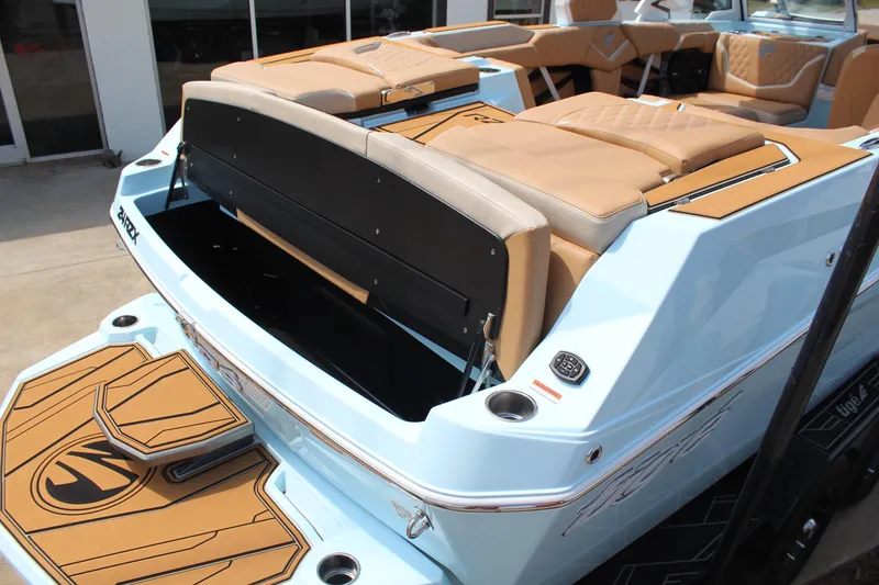 Slide: The Image of 2026 Tigé 24RZX boat with tan seating and open storage compartment. - 6