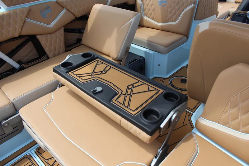 Slide: The Image of Luxurious interior of 2026 Tigé 24RZX boat with tan leather seating and cup holders. - 17