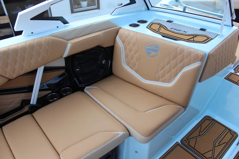 Slide: The Image of 2026 Tigé 24RZX boat interior with tan diamond-stitched seating and modern design elements. - 11