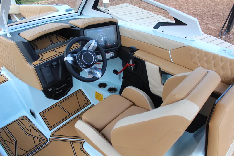Slide: The Image of 2026 Tigé 24RZX boat interior with tan leather seats and modern dashboard. - 10