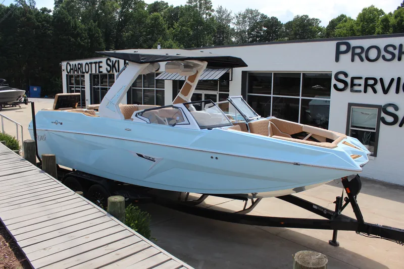 The Image of 2026 Tigé 24RZX boat in light blue, displayed at a dealership. - 1