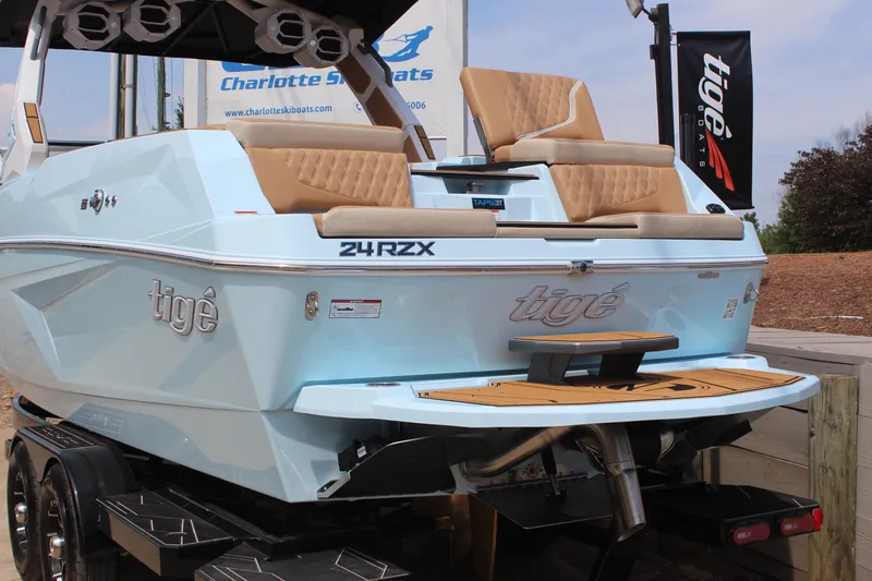 Slide: The Image of 2026 Tigé 24RZX boat with sleek design and luxurious seating, displayed on a trailer. - 4