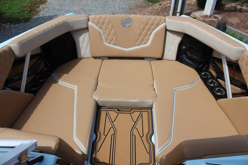 Slide: The Image of 2026 Tigé 24RZX boat interior with tan upholstery and cup holders. - 8